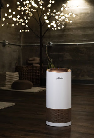 Hunter HP450UV True HEPA Cylindrical Tower Air Purifier with UVC Light Technology, White and Rose Gold, Lifestyle Photo, Unit in Yoga Studio